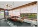 Cozy sunroom with large windows, comfortable seating, and a ceiling fan at 1924 Seclusion Dr, Port Orange, FL 32128