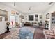 Bright living room featuring a plush grey sofa, a unique blue rug and several framed pieces of artwork at 1924 Seclusion Dr, Port Orange, FL 32128