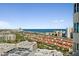 Panoramic aerial view showcasing the city skyline, ocean, and a residential community with red-tile roofs at 2 Oceans West Blvd # 1905, Daytona Beach Shores, FL 32118