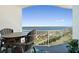 Enjoy outdoor dining on the balcony with seating and a view of the surrounding community and water at 2 Oceans West Blvd # 1905, Daytona Beach Shores, FL 32118