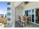 Outdoor balcony featuring a dining table, seating, and sweeping city views at 2 Oceans West Blvd # 1905, Daytona Beach Shores, FL 32118