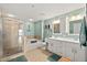 Bathroom featuring a glass-enclosed shower, soaking tub, double sink vanity, and nautical decor at 2 Oceans West Blvd # 1905, Daytona Beach Shores, FL 32118
