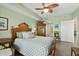 Bright bedroom featuring stylish furniture, wood floors, and fresh green paint at 2 Oceans West Blvd # 1905, Daytona Beach Shores, FL 32118