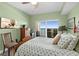 Bright bedroom with ceiling fan, wood floors, a balcony and beautiful views of the water at 2 Oceans West Blvd # 1905, Daytona Beach Shores, FL 32118