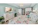 Nautical bedroom with a large-screen TV, a dresser, overhead lighting and a comfortable bed with decorative pillows at 2 Oceans West Blvd # 1905, Daytona Beach Shores, FL 32118