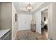 Inviting entryway with decorative rug, closet and office nook, and an elegant light fixture at 2 Oceans West Blvd # 1905, Daytona Beach Shores, FL 32118