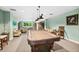 Community game room with a pool table, lounge chairs, a library, and ample lighting at 2 Oceans West Blvd # 1905, Daytona Beach Shores, FL 32118