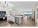 Open kitchen with island, stainless appliances, and views of the dining and living areas with water views at 2 Oceans West Blvd # 1905, Daytona Beach Shores, FL 32118