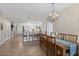 Open-concept living space with a dining room, kitchen with bar seating, and light-colored wood flooring at 2 Oceans West Blvd # 1905, Daytona Beach Shores, FL 32118