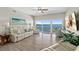 Bright living room with floor to ceiling windows and tile floors offers breathtaking water views at 2 Oceans West Blvd # 1905, Daytona Beach Shores, FL 32118