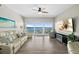 Bright living room with floor to ceiling windows and tile floors offers breathtaking water views at 2 Oceans West Blvd # 1905, Daytona Beach Shores, FL 32118