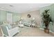 Comfortable lobby with coastal decor, a sofa, two chairs, a decorative wreath, and a plant at 2 Oceans West Blvd # 1905, Daytona Beach Shores, FL 32118