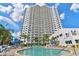 Exterior view of a high-rise condo with a pool and seating for residents to enjoy the Florida sunshine at 2 Oceans West Blvd # 1905, Daytona Beach Shores, FL 32118