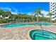 Resort-style swimming pool surrounded by lush landscaping, poolside seating and a luxurious hot tub at 2 Oceans West Blvd # 1905, Daytona Beach Shores, FL 32118
