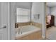 Bathroom features a garden tub with a view into the bedroom through an archway at 205 Victoria Trails Blvd, Deland, FL 32724