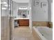 Bathroom features a walk-in shower, garden tub, vanity, and view into main bedroom at 205 Victoria Trails Blvd, Deland, FL 32724