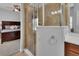 Bathroom includes a glass shower and a view into the bedroom with neutral colored walls at 205 Victoria Trails Blvd, Deland, FL 32724