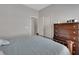Bedroom featuring bed with a decorative wood headboard, light blue bedding, and a wood dresser at 205 Victoria Trails Blvd, Deland, FL 32724
