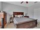 Well-lit bedroom with a king bed, nightstands, and a dresser with a view into the closet at 205 Victoria Trails Blvd, Deland, FL 32724