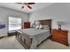 Spacious bedroom featuring a large window and a king bed with matching nightstands and dressers at 205 Victoria Trails Blvd, Deland, FL 32724