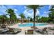 Community pool features a large pool area with plenty of lounge chairs surrounded by palm trees at 205 Victoria Trails Blvd, Deland, FL 32724