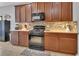 Well-equipped kitchen boasts black appliances, tiled backsplash, and plenty of cabinet storage at 205 Victoria Trails Blvd, Deland, FL 32724