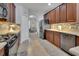 Spacious kitchen with stainless steel appliances and granite countertops flows into the living area at 205 Victoria Trails Blvd, Deland, FL 32724