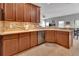 Well-lit kitchen features stainless steel dishwasher, tiled backsplash, and ample cabinet space at 205 Victoria Trails Blvd, Deland, FL 32724