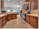 Spacious kitchen boasts dark wood cabinets and stainless steel appliances at 205 Victoria Trails Blvd, Deland, FL 32724