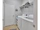 Laundry room features a washer and dryer with wire shelving above for storage and a door at 205 Victoria Trails Blvd, Deland, FL 32724