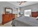 Main bedroom with a large window, a dresser with a mirror, and a peek into the bathroom at 205 Victoria Trails Blvd, Deland, FL 32724