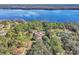 Aerial view of a home showcasing its backyard, neighboring trees and lake at 2111 Hontoon Rd, Deland, FL 32720