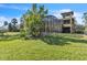 Expansive backyard featuring a screened-in pool area, lush lawn, and mature trees at 2111 Hontoon Rd, Deland, FL 32720