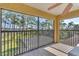 Balcony showcasing views of a lush backyard and lake at 2111 Hontoon Rd, Deland, FL 32720
