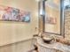 Half bath with custom stone sink, stylish faucet, mosaic tile accent, and custom mirror at 2111 Hontoon Rd, Deland, FL 32720