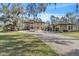 Elegant estate showcasing lush landscaping, a circular driveway, and a spacious multi-car garage for luxurious living at 2111 Hontoon Rd, Deland, FL 32720