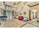 Grand foyer featuring a staircase, marble flooring, elegant lighting, and views of the home's interior at 2111 Hontoon Rd, Deland, FL 32720