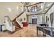 Spacious foyer featuring a grand staircase, beautiful chandelier, and travertine tile flooring at 2111 Hontoon Rd, Deland, FL 32720