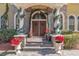Charming front entrance with double doors, stone accents, and festive decor at 2111 Hontoon Rd, Deland, FL 32720