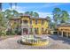 Stately home featuring a circular driveway with a fountain and a classic Mediterranean design at 2111 Hontoon Rd, Deland, FL 32720