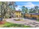 Exterior of a home featuring a circle driveway, fountain, and a porte-cochere at 2111 Hontoon Rd, Deland, FL 32720