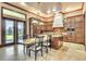 Bright kitchen with custom cabinets, island with seating, stainless appliances, and views of the backyard at 2111 Hontoon Rd, Deland, FL 32720