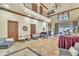 Grand living room with soaring ceilings, wrought iron balcony, travertine floors and elegant chandelier at 2111 Hontoon Rd, Deland, FL 32720
