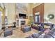 Cozy living room with high ceilings, a fireplace, leather sofas, and a large window with natural light at 2111 Hontoon Rd, Deland, FL 32720