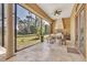 Covered outdoor kitchen with built-in grill, sink, and dining area, perfect for entertaining guests at 2111 Hontoon Rd, Deland, FL 32720