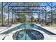 Sparkling pool and spa enclosed by a screen, offering a serene view of the backyard at 2111 Hontoon Rd, Deland, FL 32720