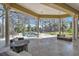 Enclosed pool area with travertine tile, featuring an adjacent spa and lounge chairs for relaxation at 2111 Hontoon Rd, Deland, FL 32720