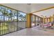 Enclosed porch featuring tiled floors and panoramic views of the surrounding landscape at 2111 Hontoon Rd, Deland, FL 32720