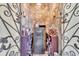 Stone walled wine cellar with secure safe, wine racks, and custom lighting behind wrought iron gates at 2111 Hontoon Rd, Deland, FL 32720