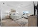 Serene main bedroom with tray ceiling, neutral decor, and a view of the landscaped yard at 2128 Raglan Cir, Ormond Beach, FL 32174